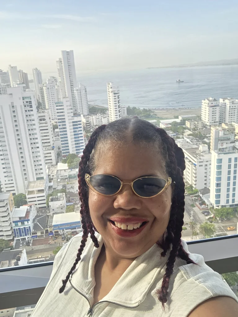 Doreen Carroll, founder of Deee Destination Agency, with a city and ocean view behind her